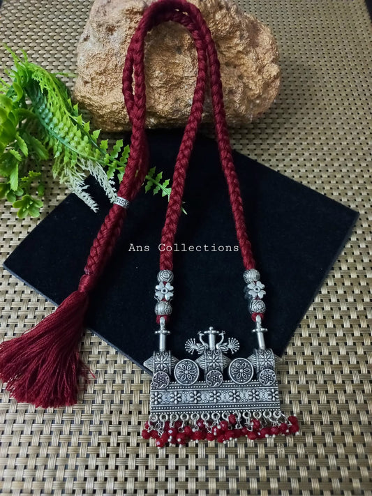 Maroon thread with oxidized pendant