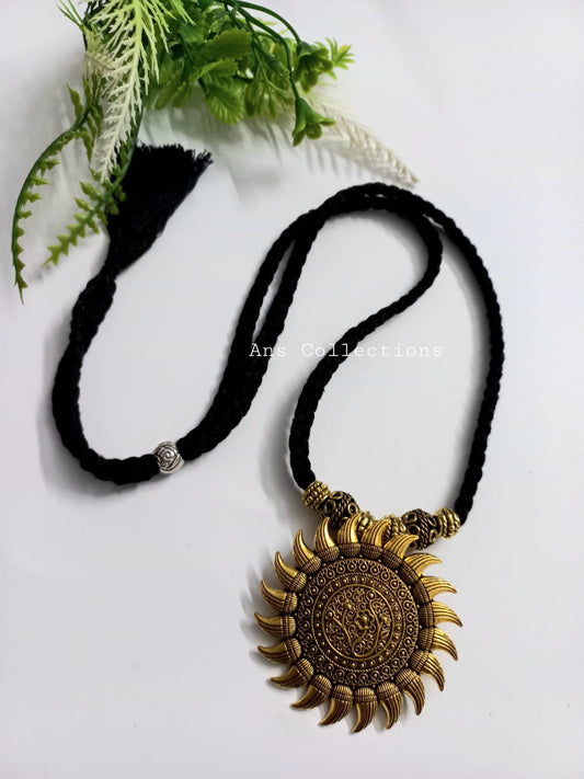 Black thread with antique gold pendant