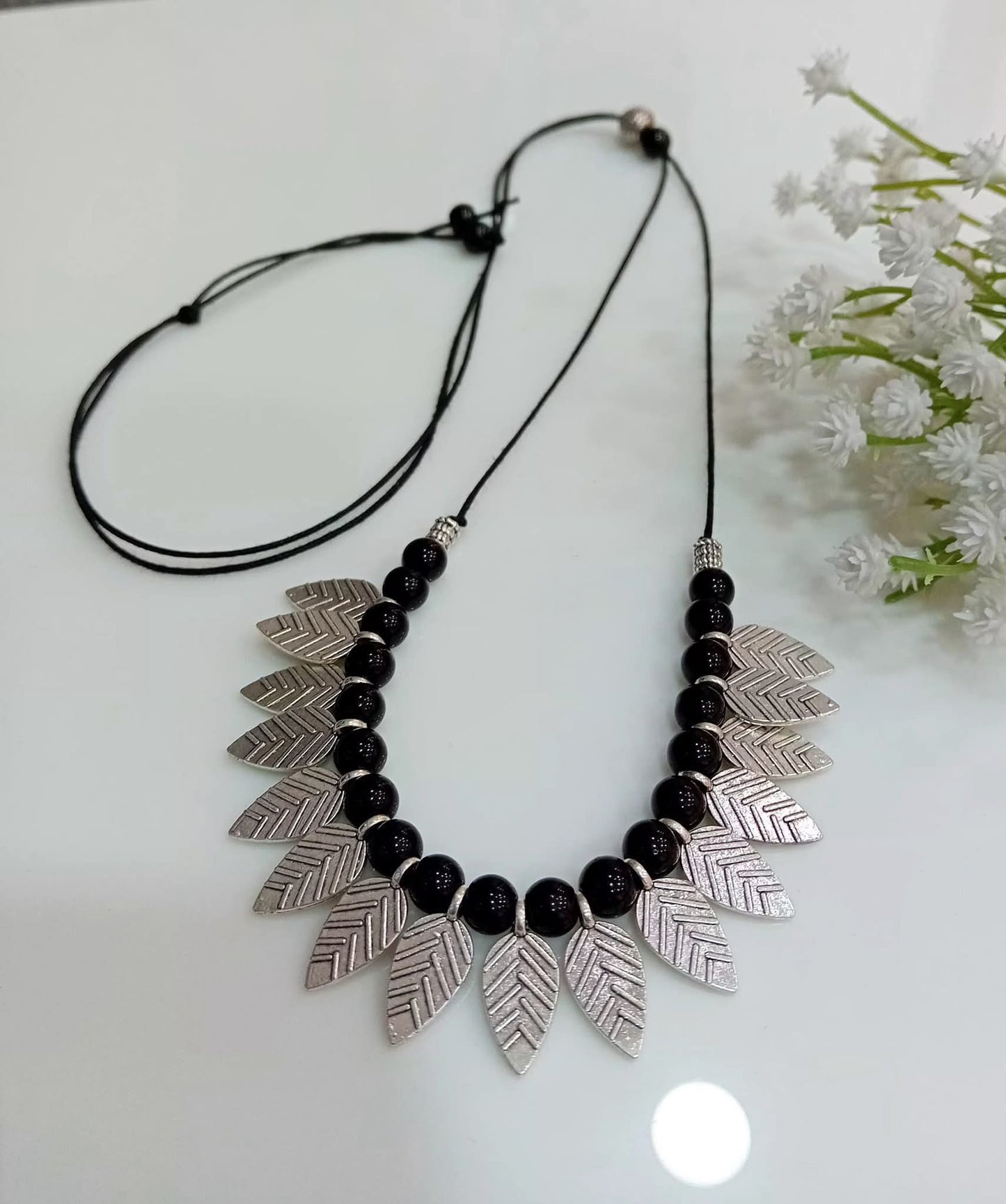 Black beads with leaf pendants